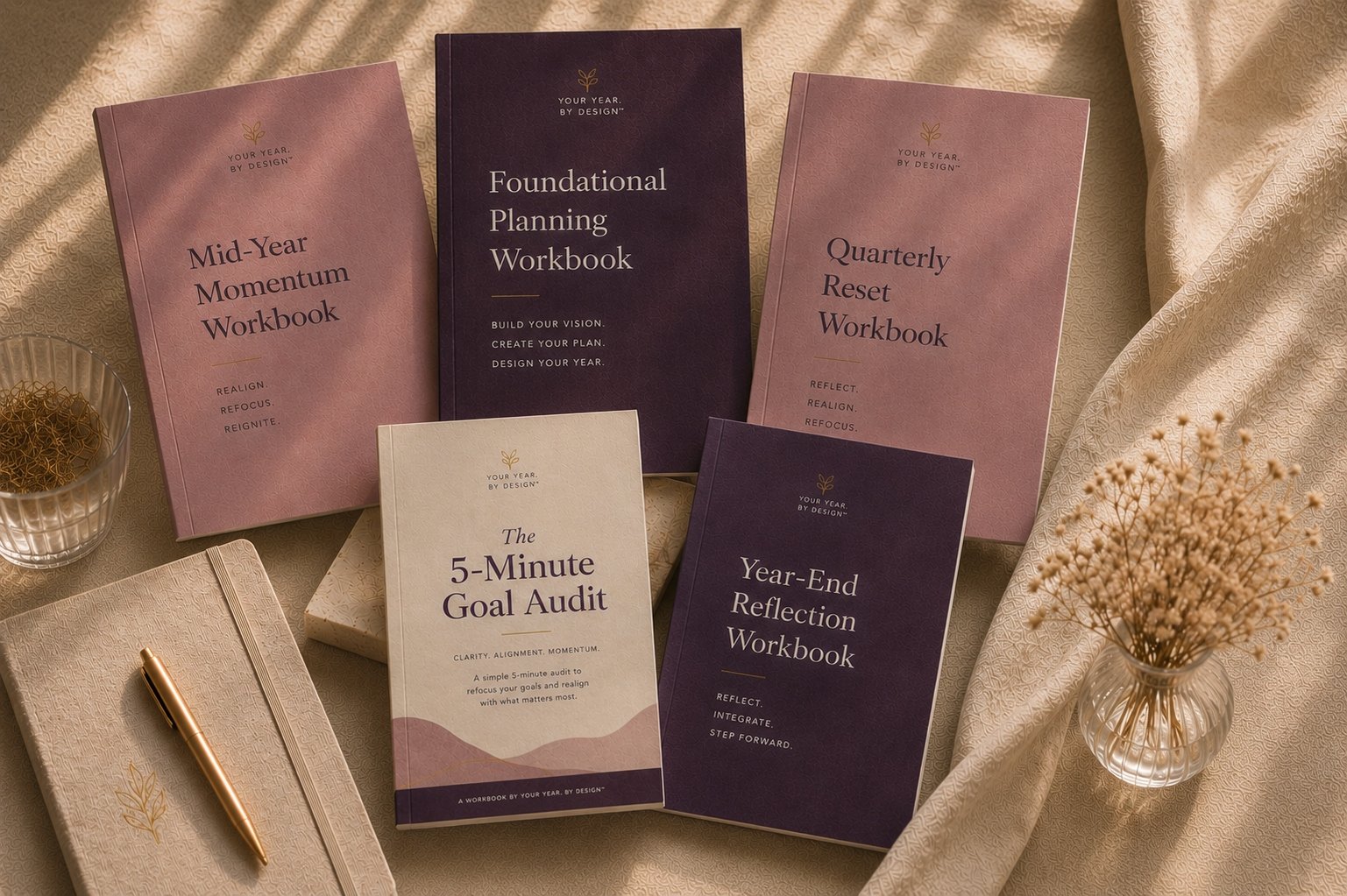 Your Year, By Design full workbook system including the Foundational Planning Workbook, Quarterly Reset Workbook, Mid-Year Momentum Workbook, Year-End Reflection Workbook, and 5-Minute Goal Audit.